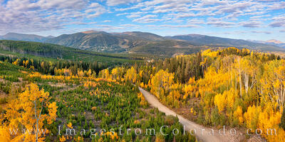 From high up on Corona Pass Road, this view of the Winter Park Ski area is seen through the golden colors of Aspen on a cool Autumn morning.