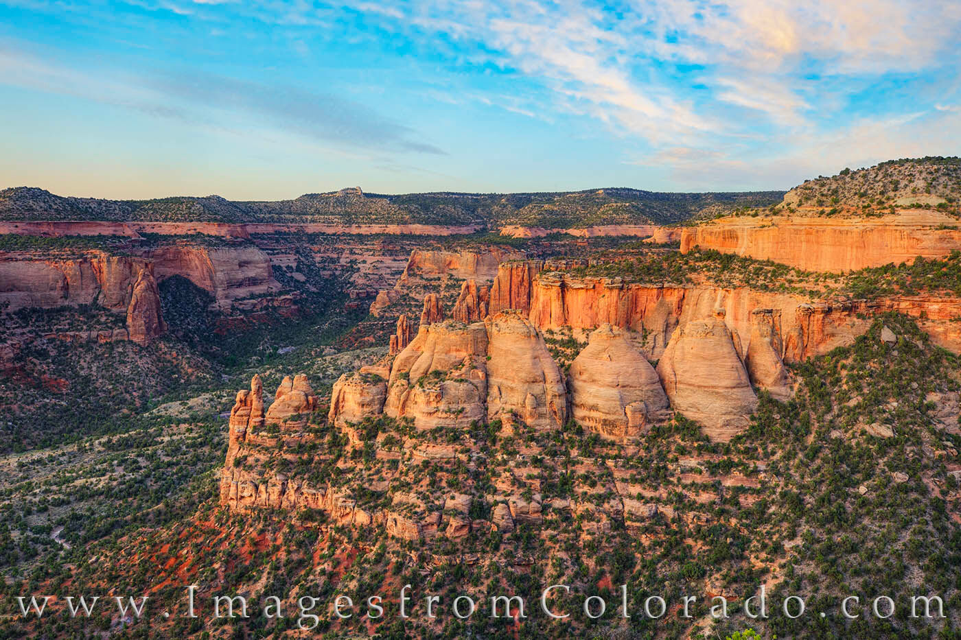 Just before sunrise, the soft pastel skies of western Colorado awaken over Colorado National Monument. This photograph shows...