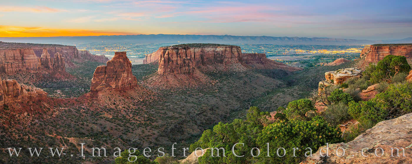 From the Grand View Overlook in Colorado National Monument, the canyon walls and rock formations are breathtaking. In the distance...