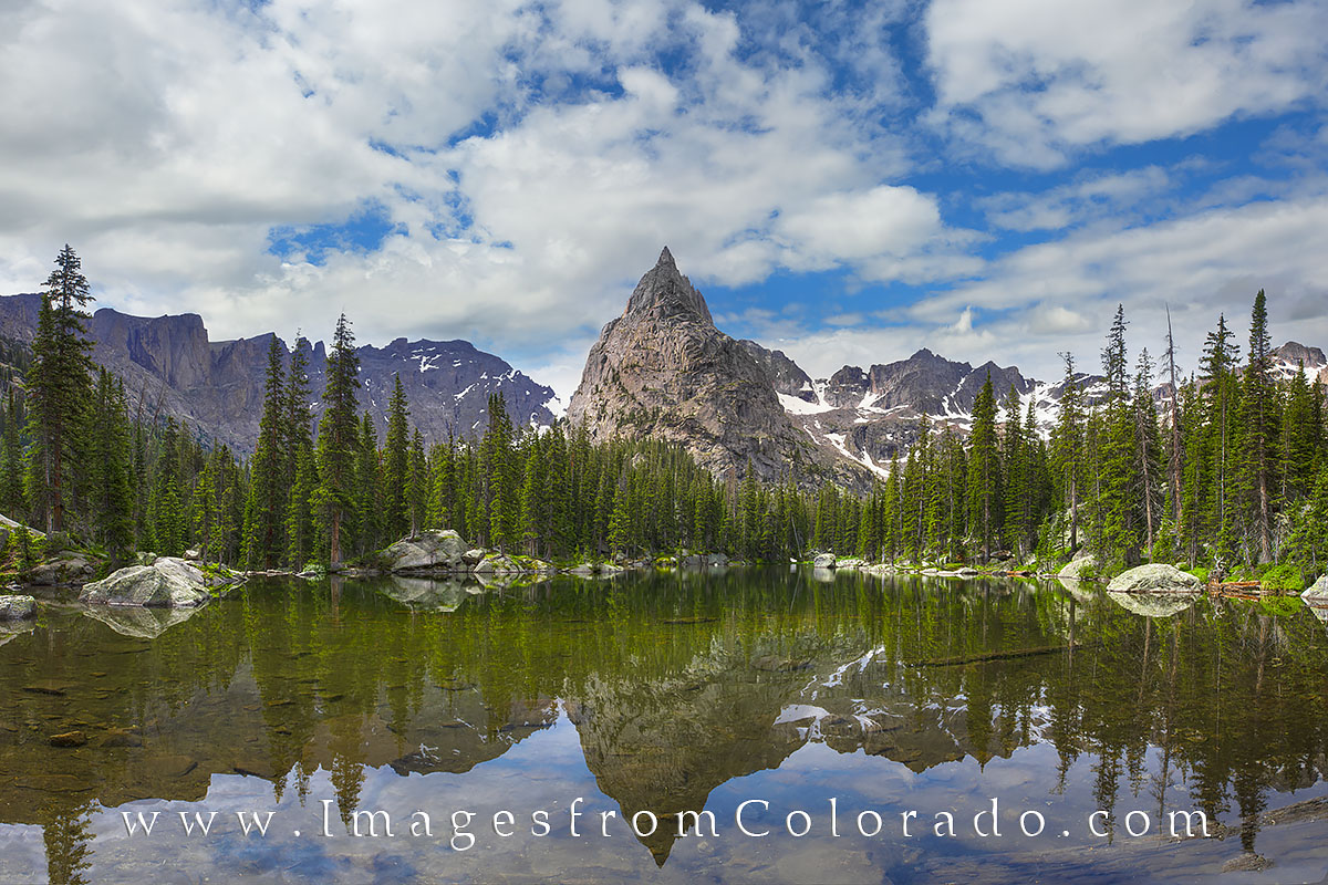 This panorama from the Indian Peaks Wilderness in Grand County shows the stunning Lone Eagle Peak as its reflection shimmers...