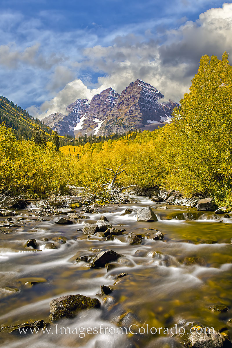 With golden aspen trees spread across the landscape, Maroon Creek flows down from the higher elevations. In the distance, the...