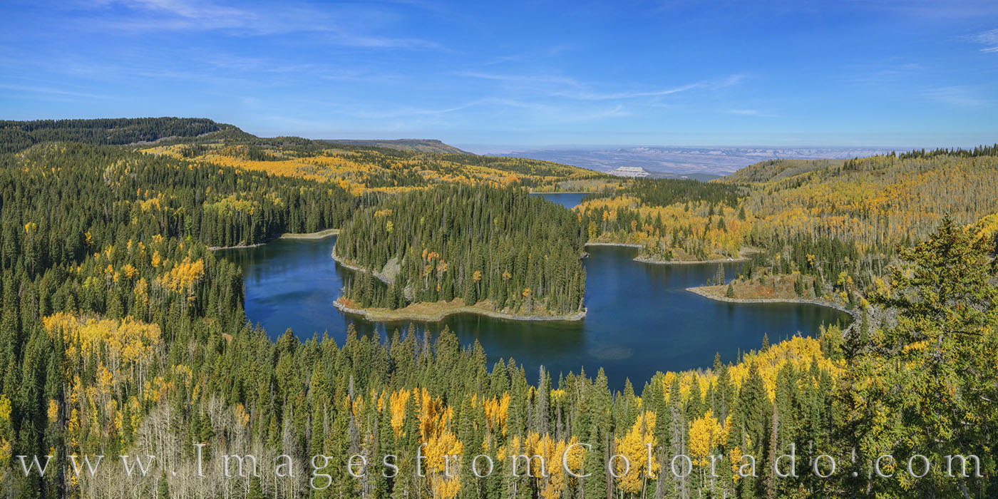 The gold of October Aspen trees stands out as the fall colors surround Mesa Lake high on the Grand Mesa. This panorama is available...