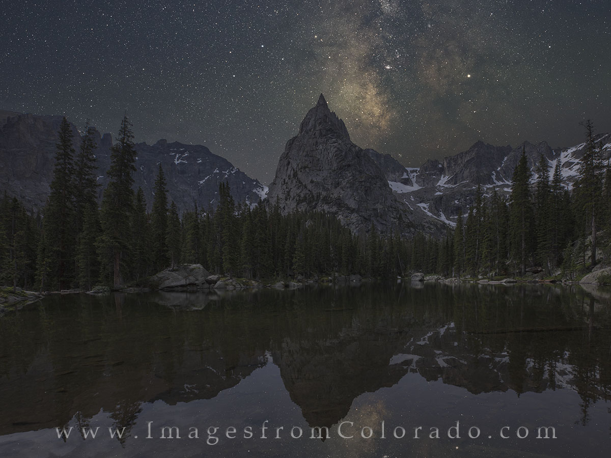 This Lone Eagle Peak image shows the June Milky Way as it looms over the valley and Mirror Lake in the Indian Peaks Wilderness...