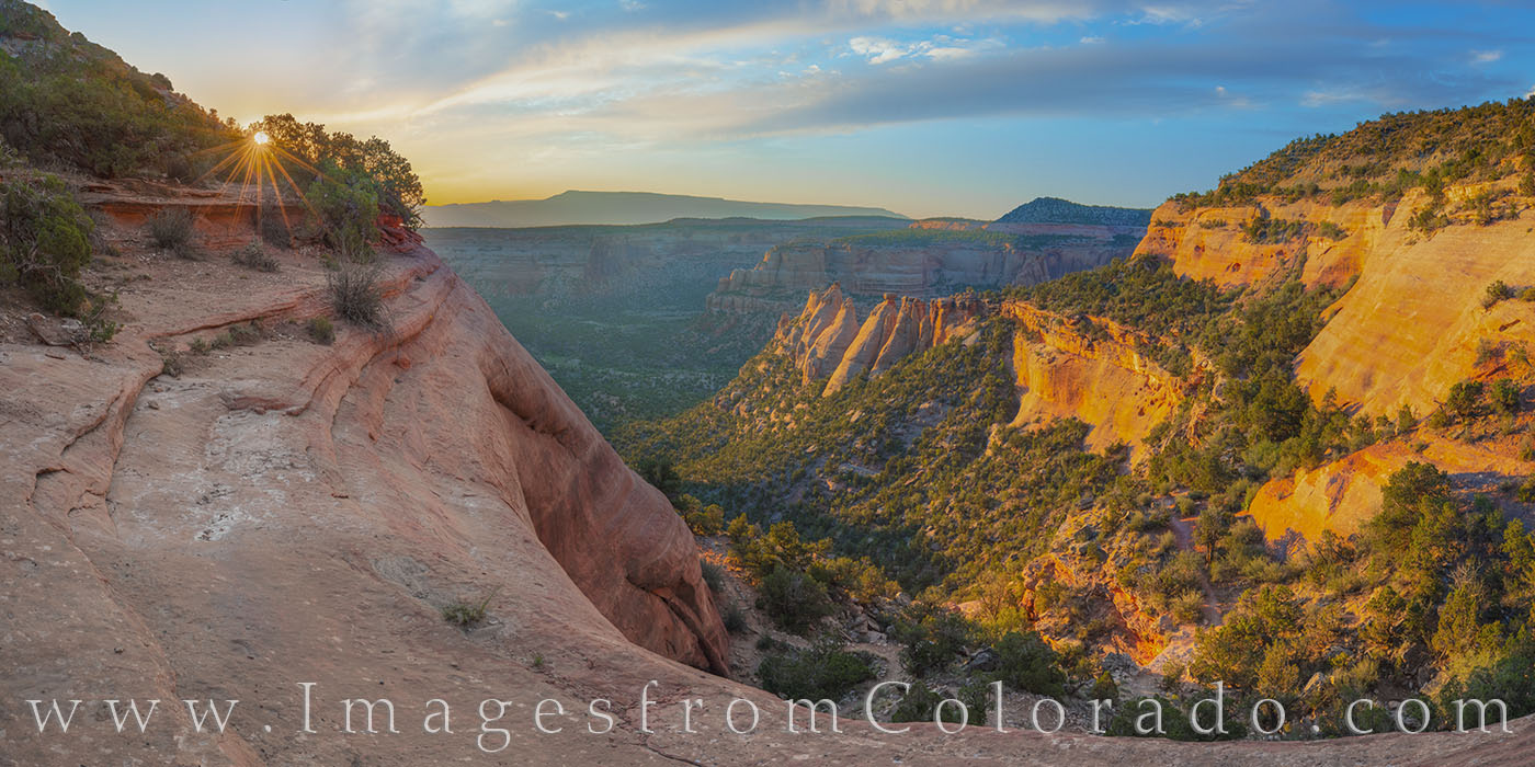 This panorama from Colorado National Monument was taken at sunrise a little ways down from the Monument Trailhead. The path is...