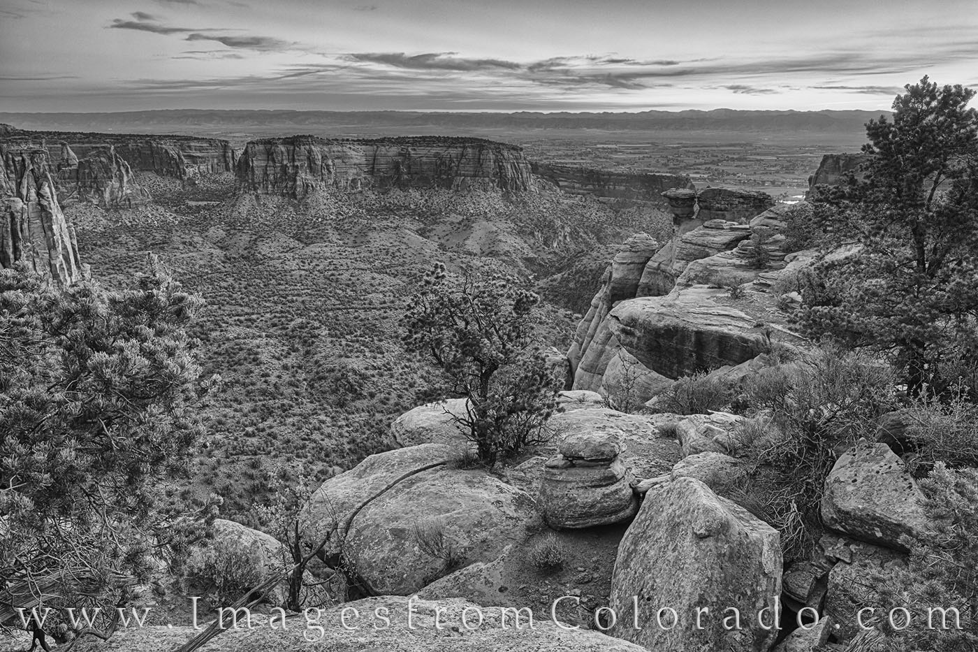 Monument Canyon comes alive at sunrise as first light begins to filter into the deep valley. This black and white photograph...