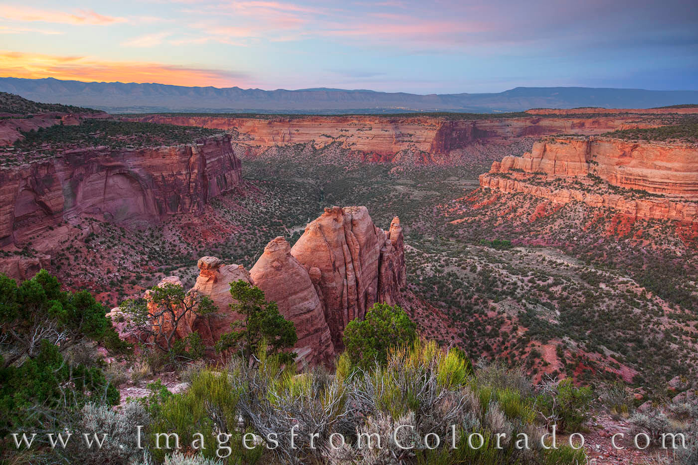 From a trail leading into Monument Canyon in Colorado National Monument, this photograph shows the canyon at sunset. The ancient...
