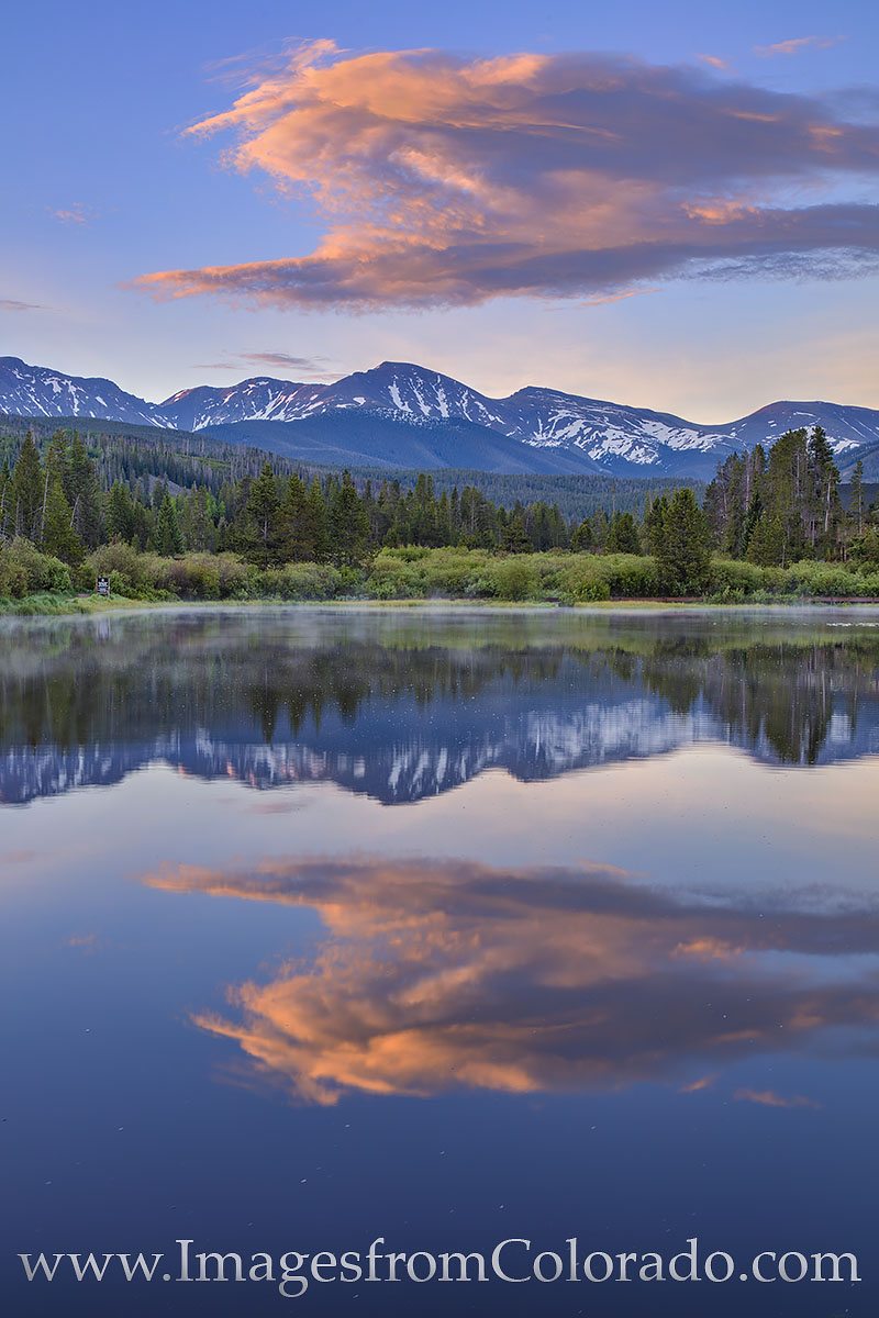 In the resort town of Winter Park, a small pond offers a clear reflection of Parry Peak and its ‘“bear claw.” This prominent...