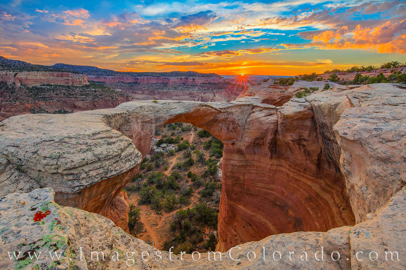From iconic Rattlesnake Arch in Rattlesnake Canyon, the evening sky lights up at the end of a July day. This beautiful area is...