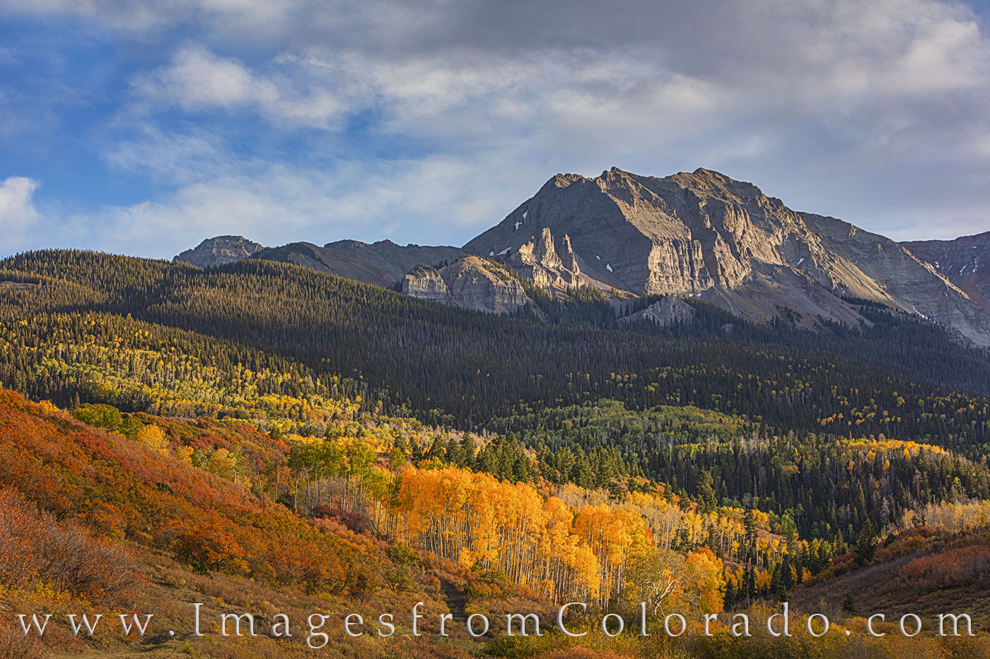 As shadows moved across the mountains and valleys of the Dallas Divide near Ridgway, Colorado, sunlight illuminated the gold...
