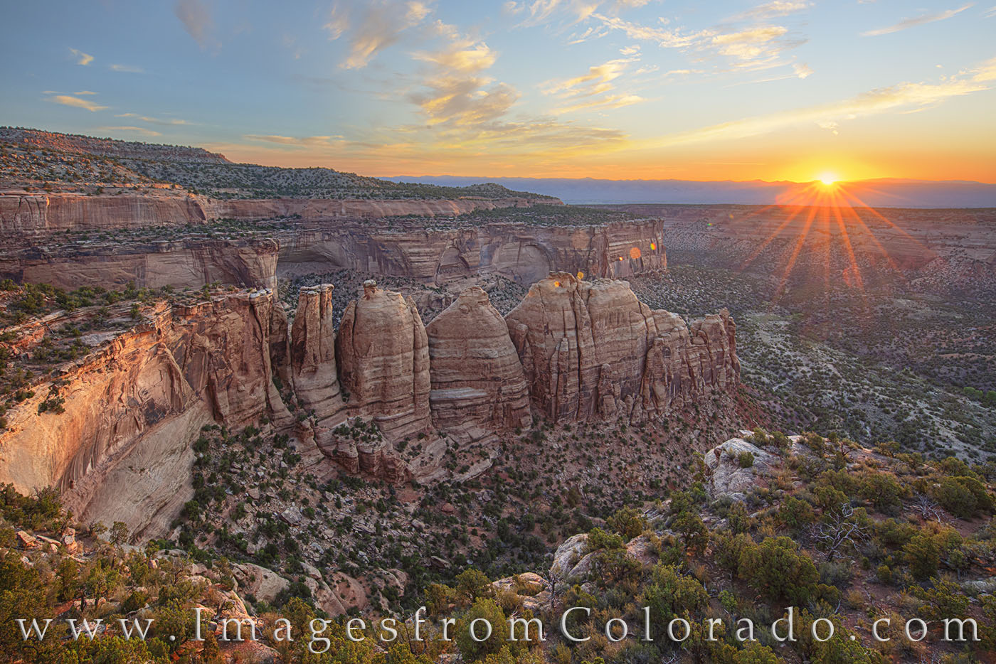 Along Rim Rock Road in Colorado National Monument, the sun rises over one of the famous viewpoints - Artist Point. Here, grand...