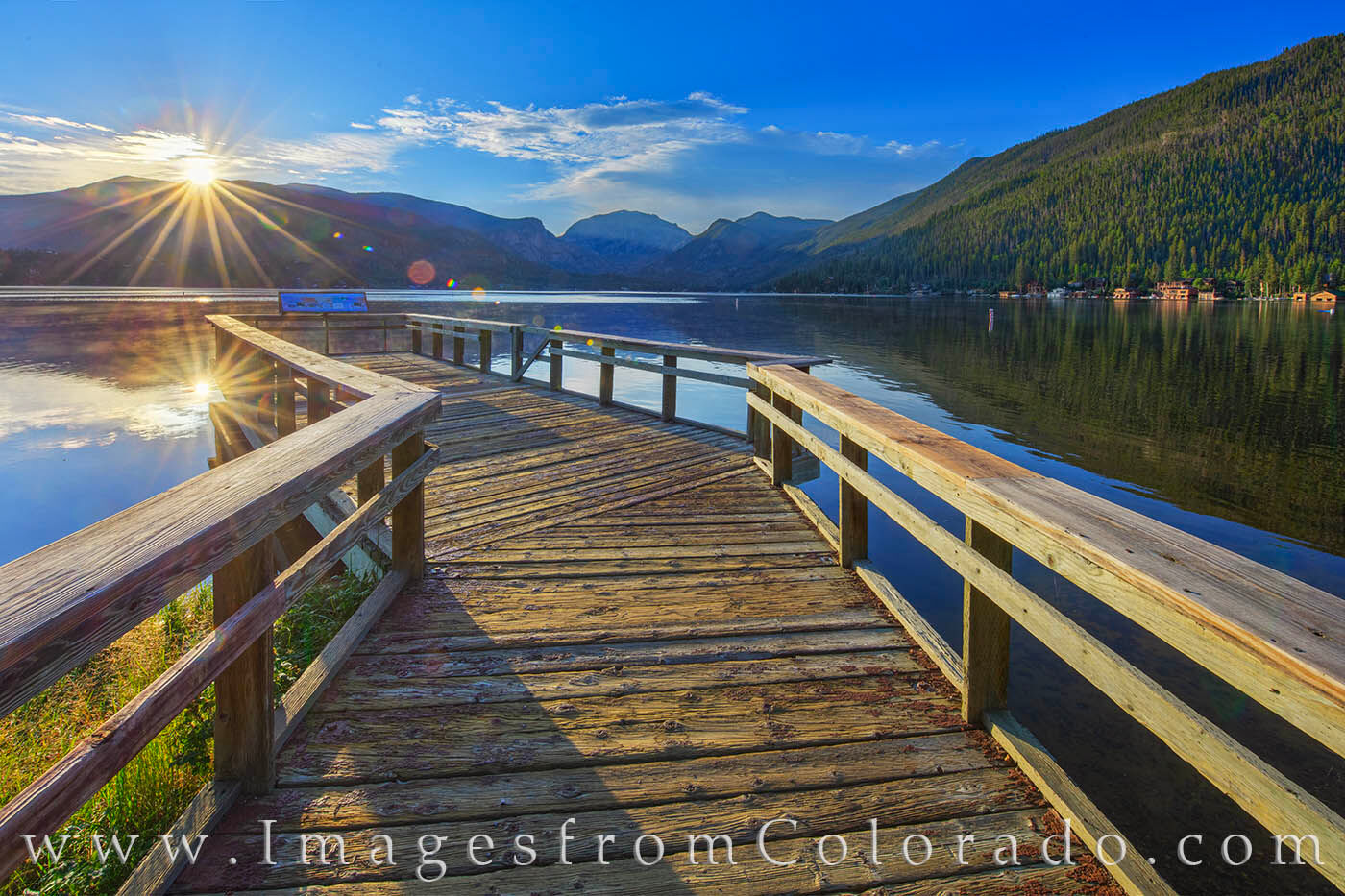 From a quiet pier on the west side of Grand Lake, the sun's first rays come streaming across the water in a burst of energy and...