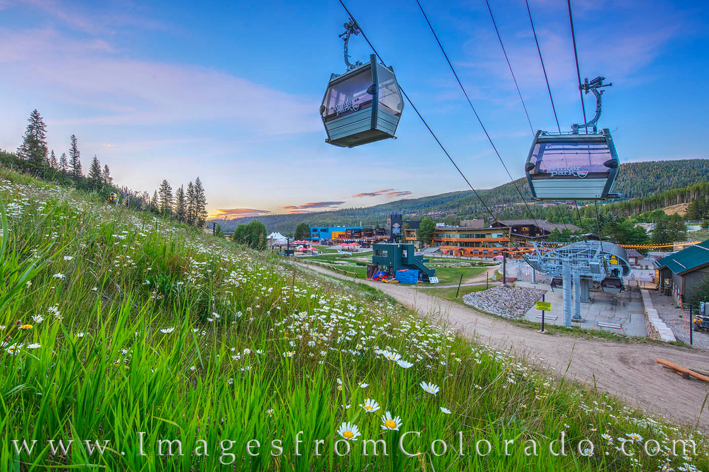 Gondolas rest quietly on a summer evening at the Winter Park base.