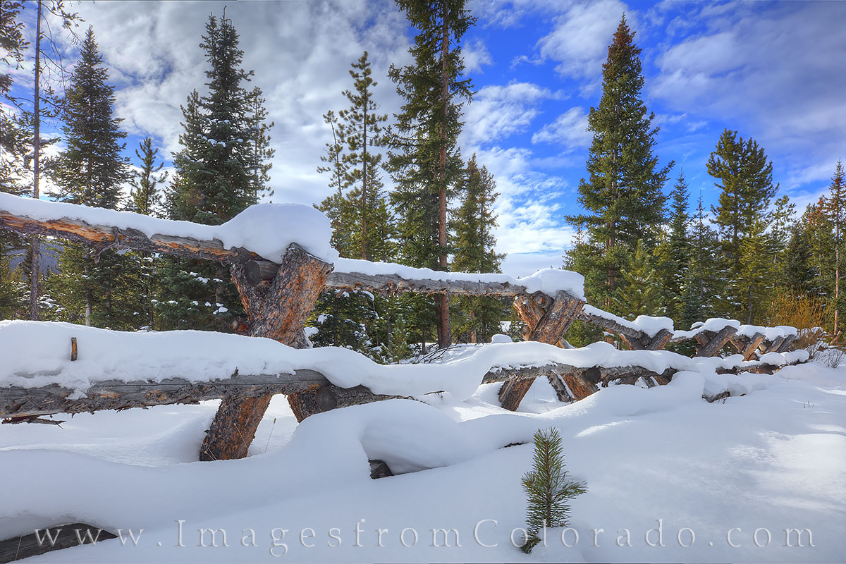 Near the St. Louis Creek Trail outside of Fraser, Colorado, an old wooden fence sits under a fresh snow and blue skies. It was...